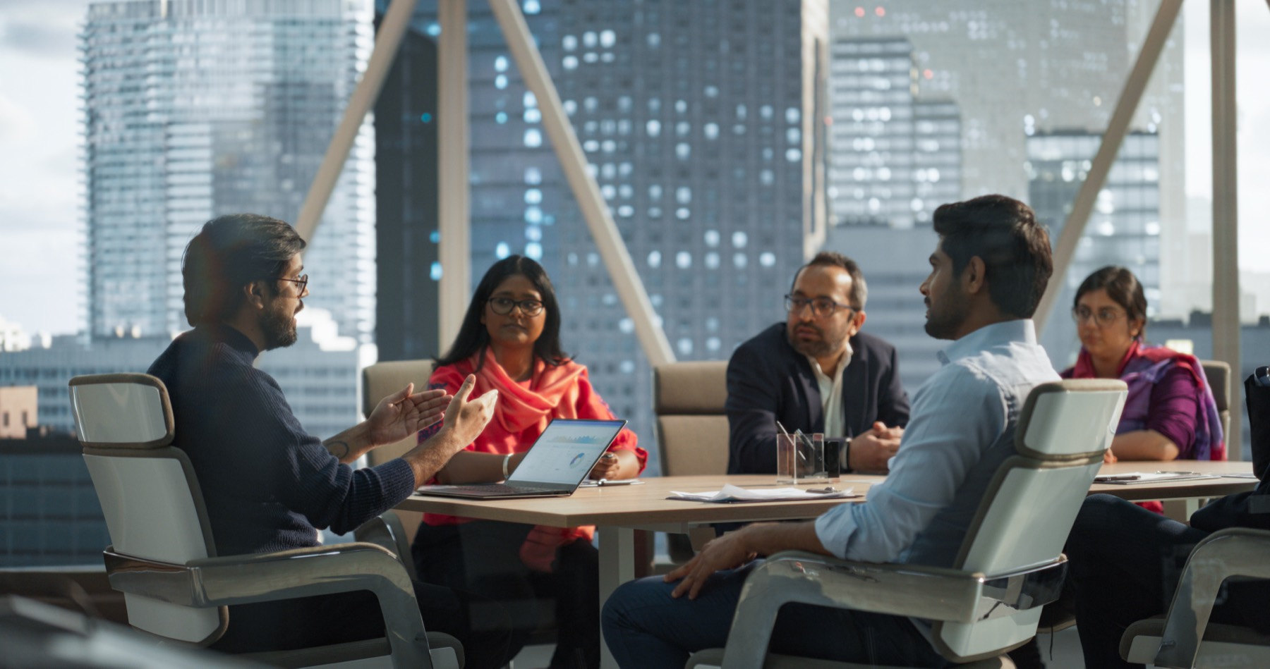 Indian professionals in discussion around a boardroom table